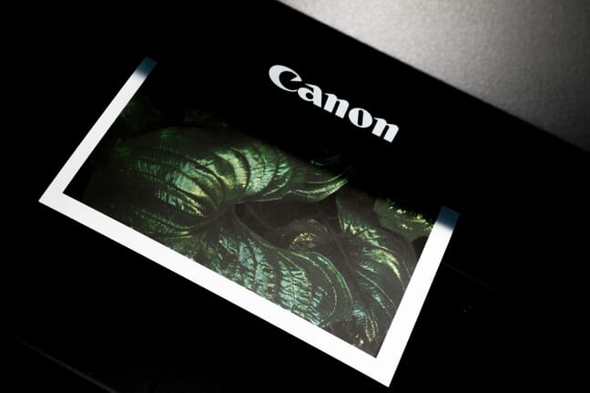 Paper photo print coming out of a Canon printer.