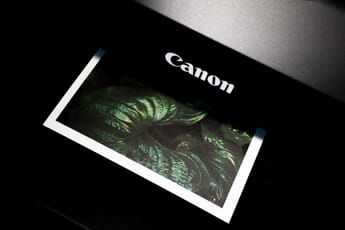 Paper photo print coming out of a Canon printer.