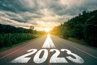 2023 sign on road with an arrow pointing forward.