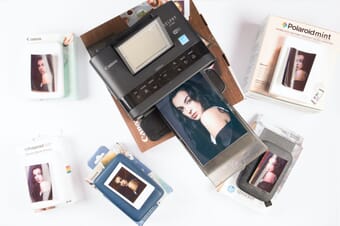 Selphy Canon CP1300 and other portable photo printers on a table