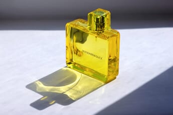 glass perfume bottle on reflective board