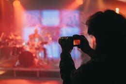 Photographer at a musical event taking a picture.