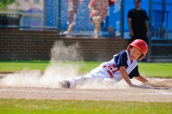 Youth baseball player sliding