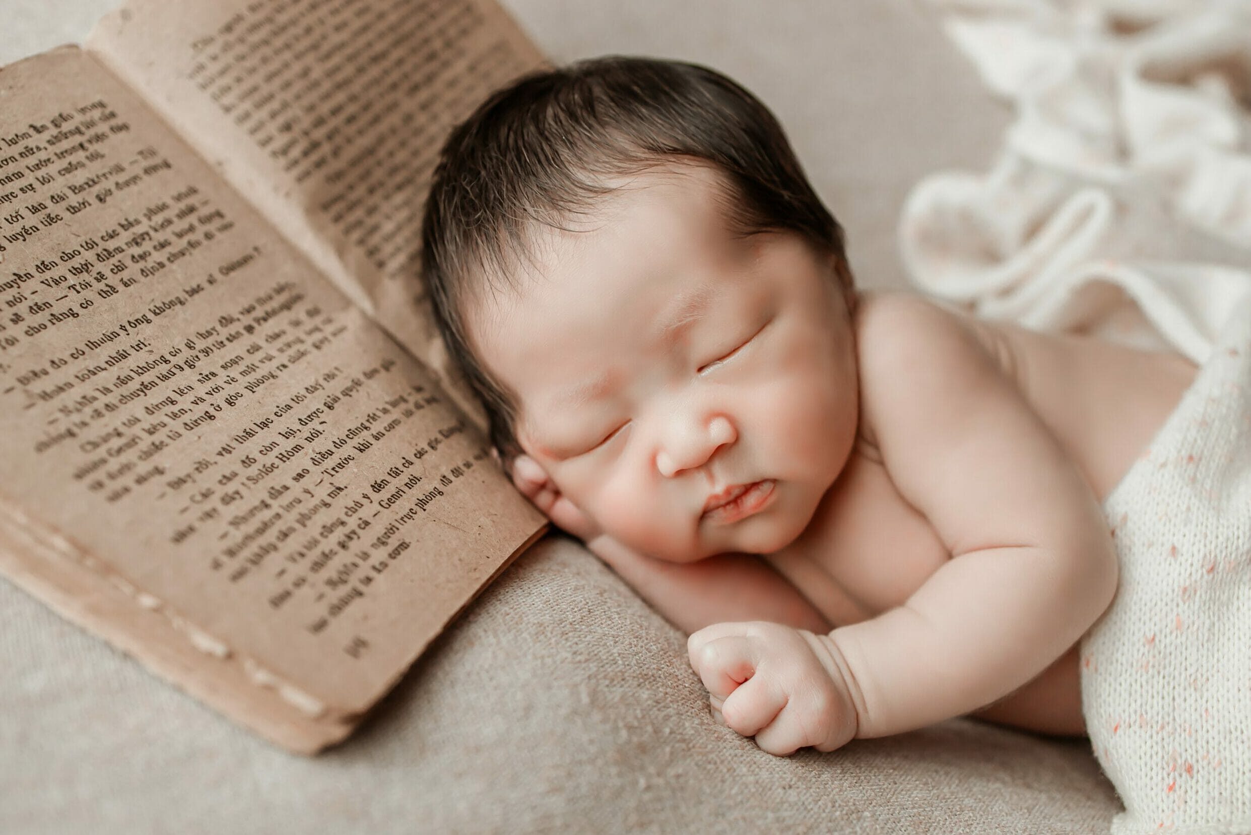 Baby sleeping with a book photo prop.
