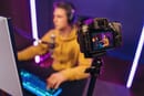Gamer sitting on a desk with a camera in front