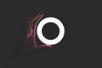 Ring light with a hand in the dark