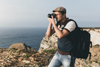 Photographer using a camera with a viewfinder