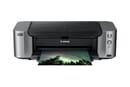 The Canon PIXMA Pro-100 printing out a photo of trees beneath the aurora at night