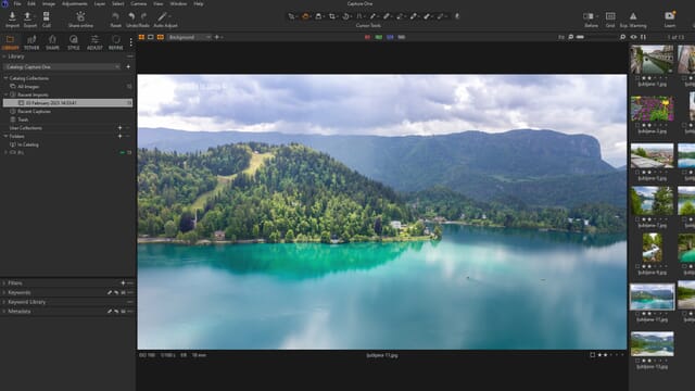 The Capture One Pro library interface with folders on the left, thumbnails on the right, and an image with a lake and forested mountains.
