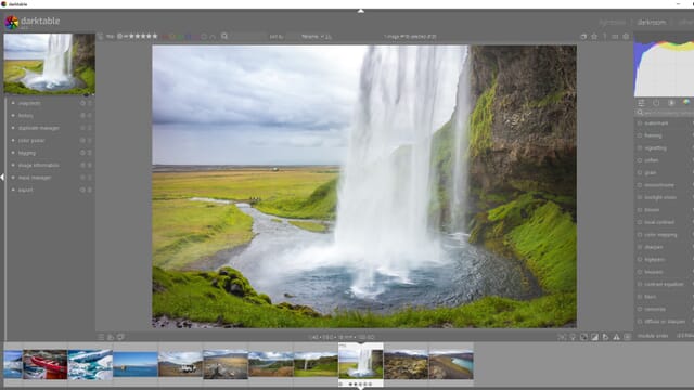 Darktable editing screen with tools, image thumbnails, and a main image showing a waterfall surrounded by grass and ominous clouds.
