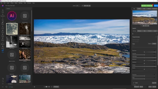 The main editing screen of ON1 Photo RAW 2023 with an image of a snowy and grassy field with glaciers in the background.