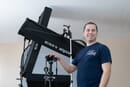 Joshua Gharis, headshot photographer, standing with his Godox lighting setup.