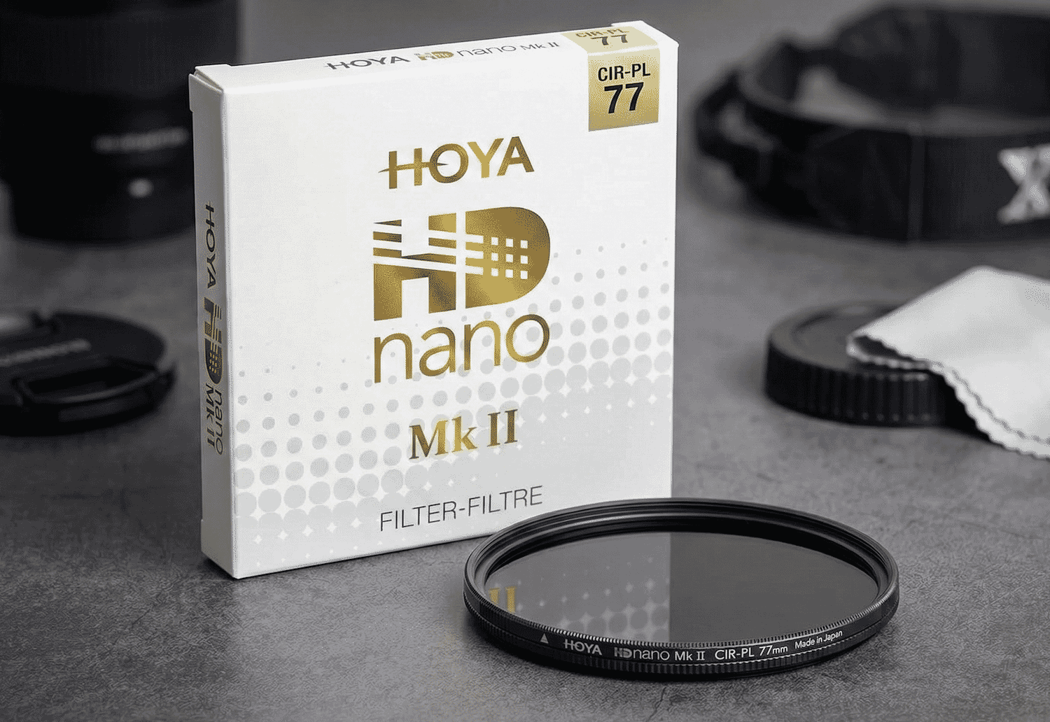 The HOYA HD Nano Mk II 77mm circular polarizer filter is displayed beside its sleek packaging, ideal for professional lens protection and glare reduction.