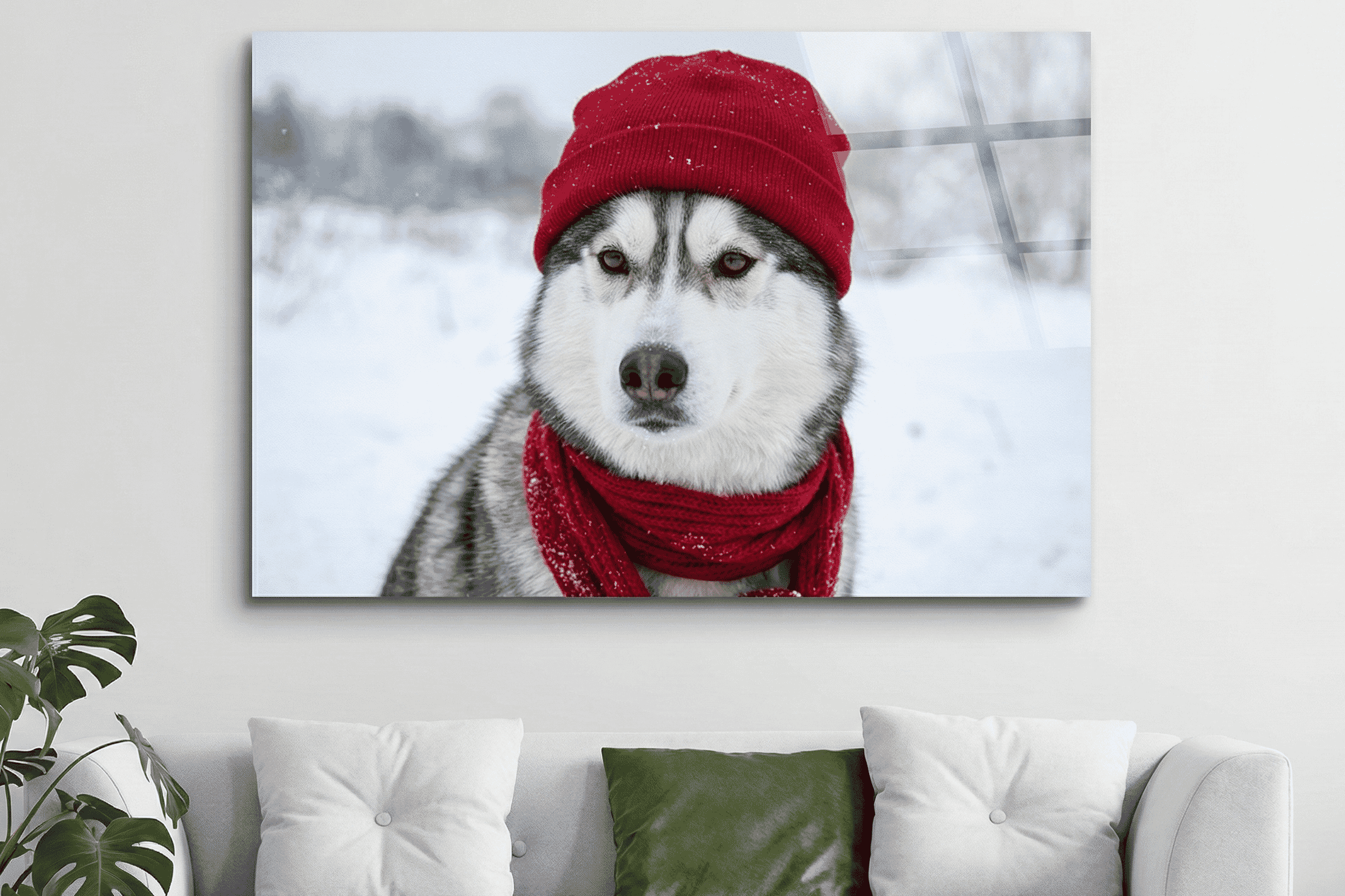 A majestic Siberian husky wearing a cozy red hat and scarf poses in a snowy winter landscape, creating a festive and heartwarming scene.