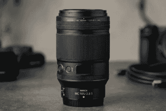 Close-up of the NIKKOR Z MC 105mm f/2.8 S VR macro lens with a sleek black design, ideal for detailed macro photography and portraits.
