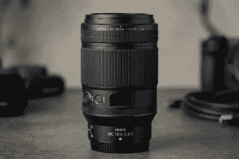 Close-up of the NIKKOR Z MC 105mm f/2.8 S VR macro lens with a sleek black design, ideal for detailed macro photography and portraits.