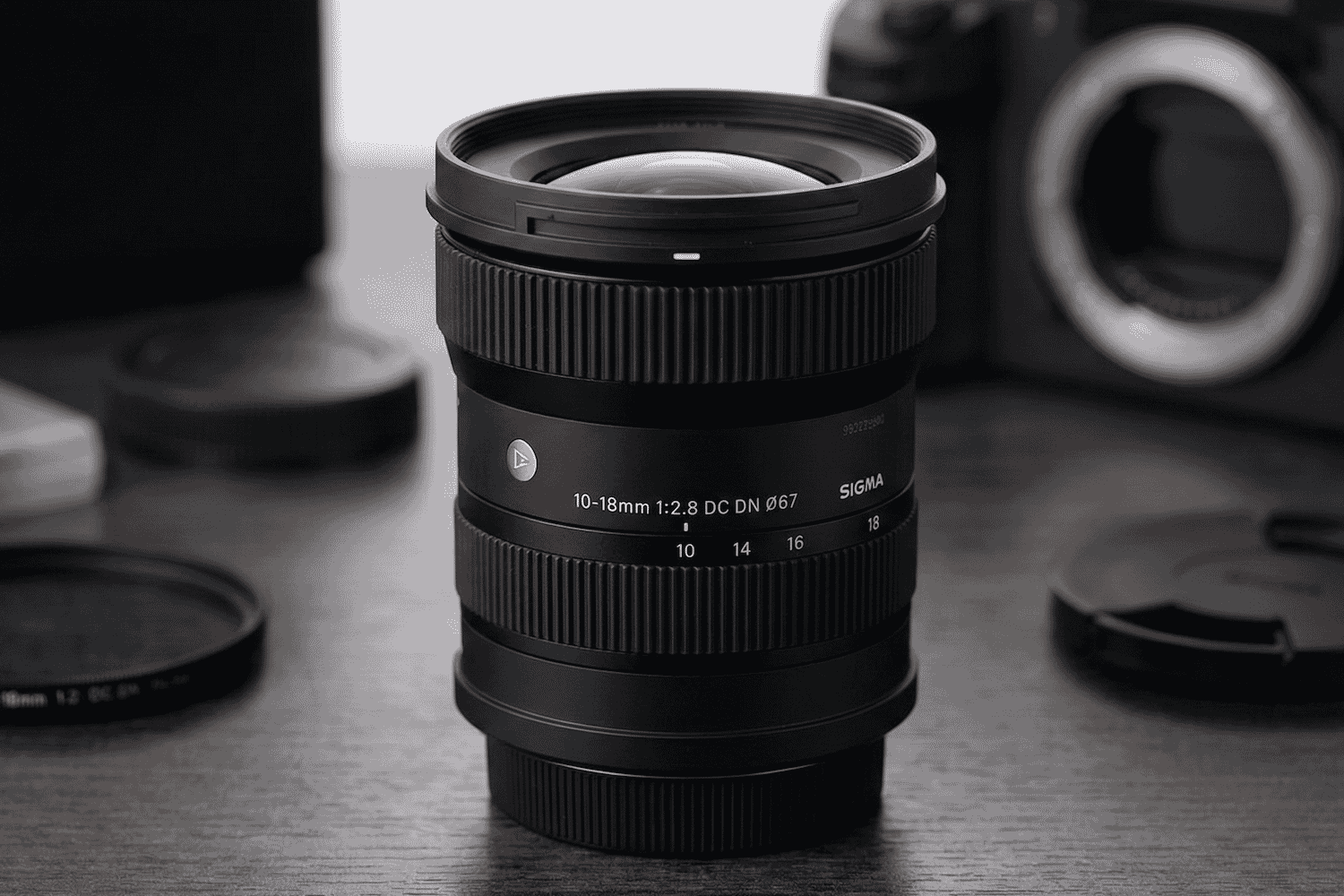 A close-up of the Sigma 10-18mm f/2.8 DC DN lens showcases its sleek design and ultra-wide zoom range for mirrorless cameras.