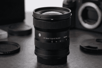 A close-up of the Sigma 10-18mm f/2.8 DC DN lens showcases its sleek design and ultra-wide zoom range for mirrorless cameras.