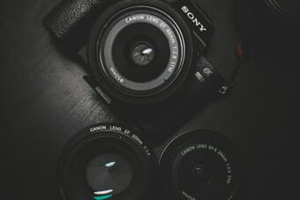 Camera on glass surface reflecting creative photography - breaking photography rules