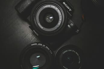 Camera on glass surface reflecting creative photography - breaking photography rules