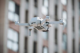 DJI drone flying in the sky - DJI sues FCC over US drone import ban