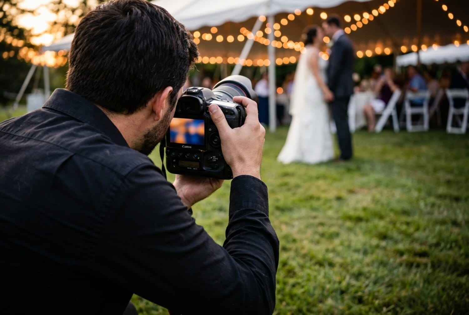 Event photographer capturing first dance at outdoor wedding reception