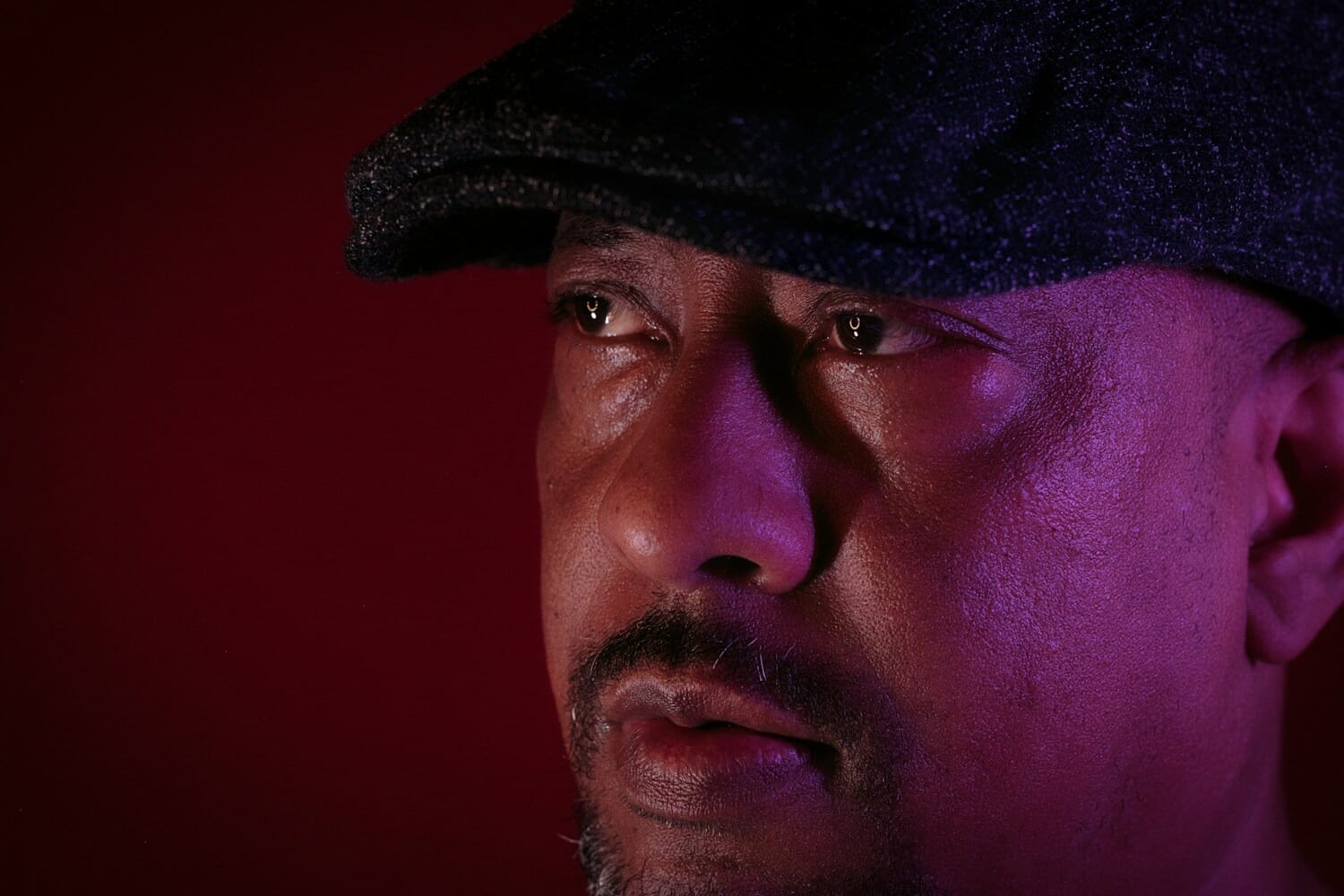 Dramatic portrait lit with colored flash lighting demonstrating high-speed sync flash technique