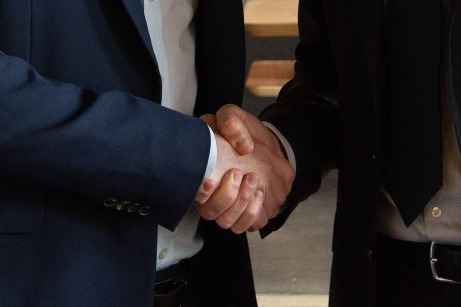 Business partners shaking hands representing the Getty Images and Shutterstock merger deal