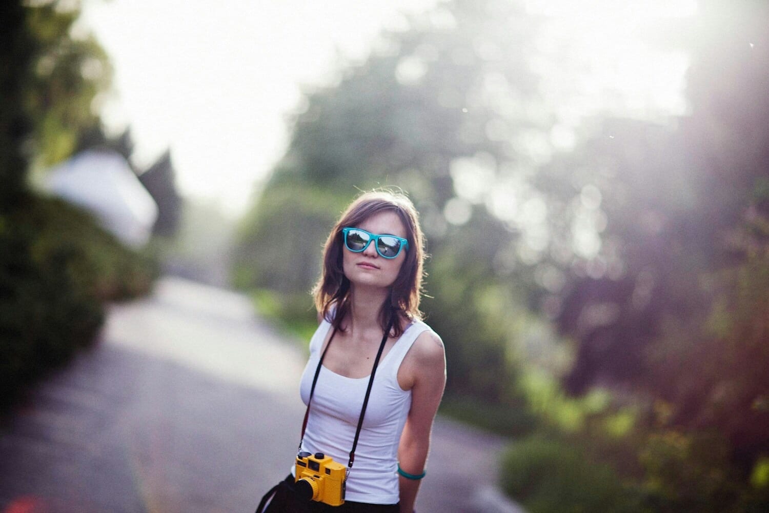 Woman holding a small compact point-and-shoot camera while traveling