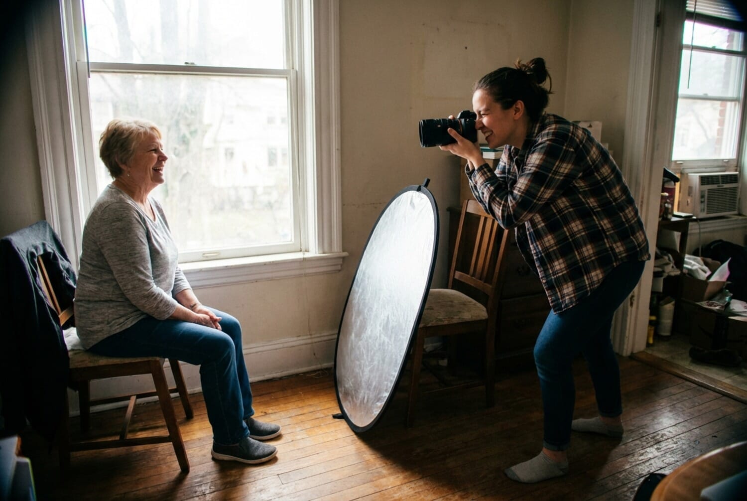 Portrait photography session showing photographer and subject during natural lighting setup
