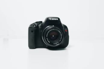 Collection of used camera lenses on a dark surface - buying guide