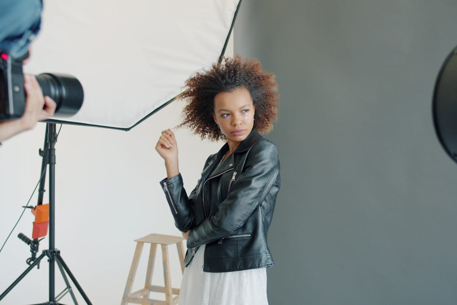 Professional portrait photography session in a studio with white background lighting setup