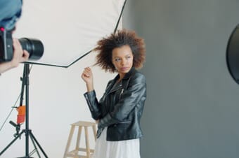 Professional portrait photography session in a studio with white background lighting setup