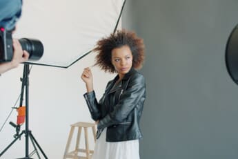 Professional portrait photography session in a studio with white background lighting setup