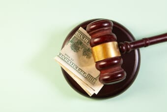 Judge gavel and money symbolizing the Adobe $150 million settlement