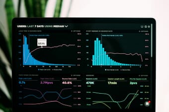 Data analytics dashboard showing performance graphs on a laptop screen, representing AI photography industry statistics