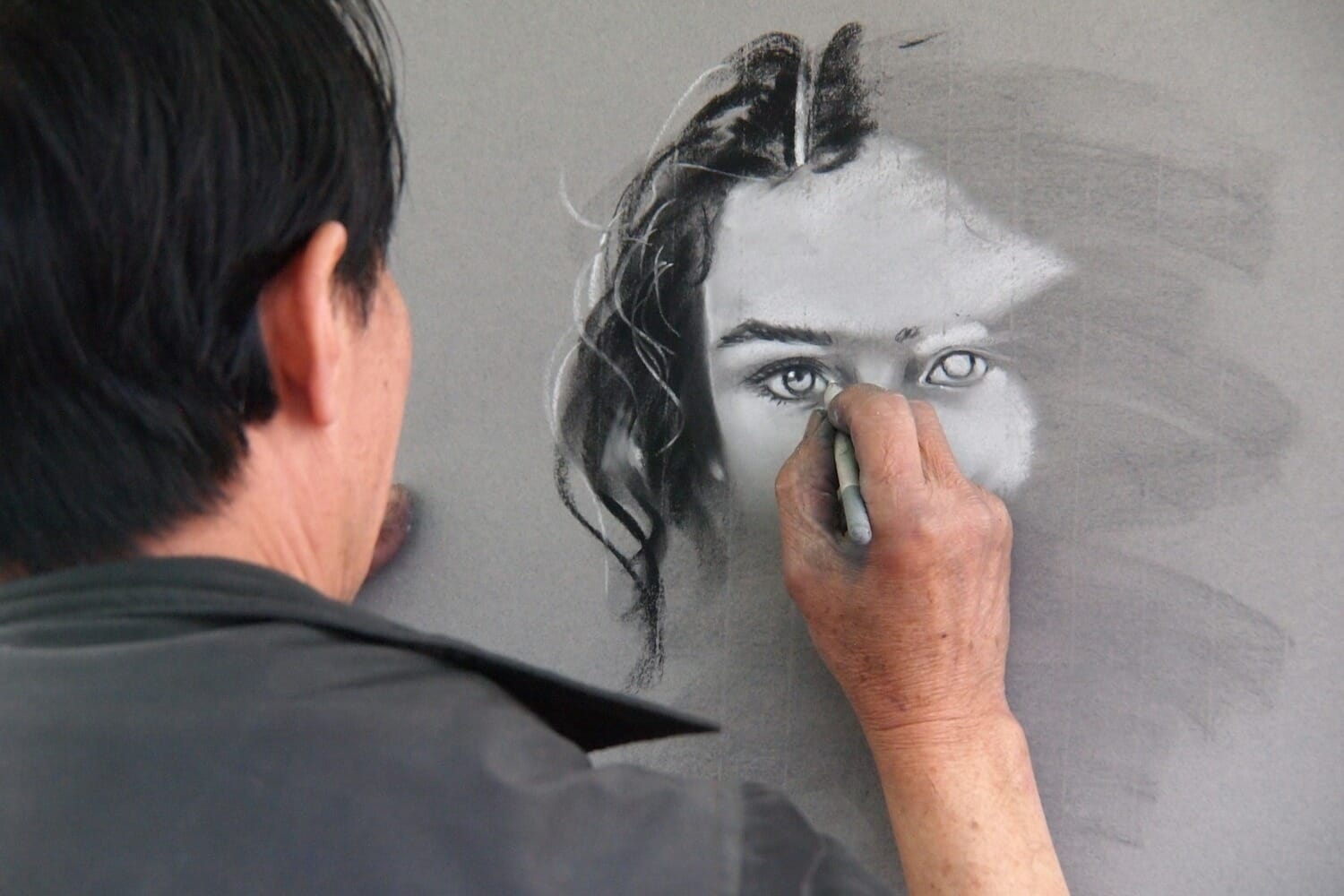 Artist drawing by hand, representing human-made creative work