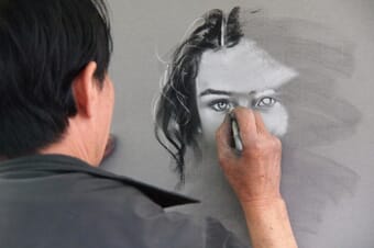 Artist drawing by hand, representing human-made creative work