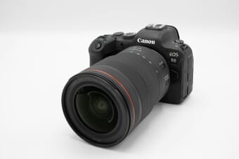 Canon EOS R6 mirrorless camera with RF lens on white surface