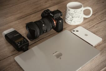 Best stock photography sites - camera, laptop, and creative tools on a workspace