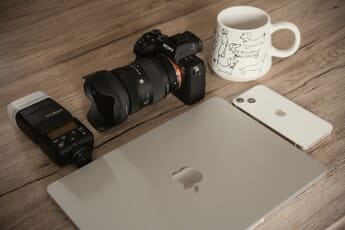 Best stock photography sites - camera, laptop, and creative tools on a workspace
