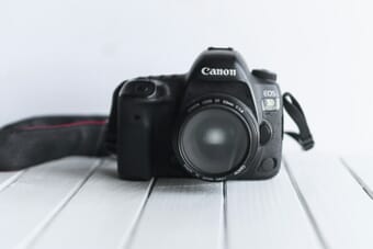 Canon EOS 5D Mark IV DSLR camera on a white surface