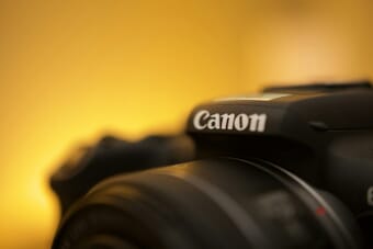 Canon camera close-up showing the Canon logo — Canon EOS R7 firmware v1.8.0 update