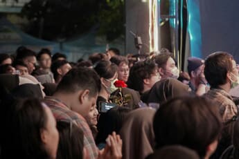 Concert stage with dramatic lighting and a crowd of fans during a live music performance