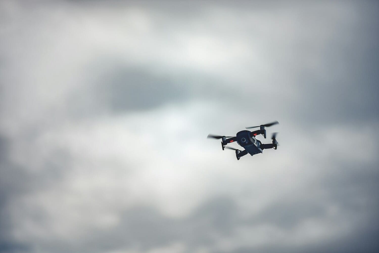 DJI drone flying in cloudy sky - representing the new DJI Avata 360 drone