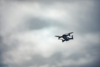 DJI drone flying in cloudy sky - representing the new DJI Avata 360 drone