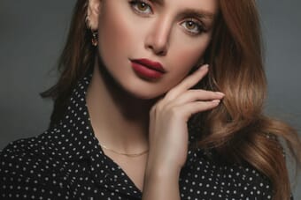 Fashion photographer working with a model in a professional studio setup