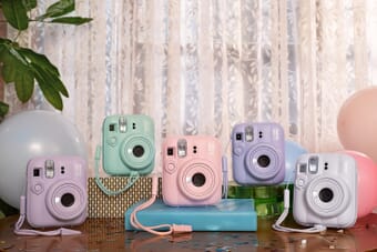 Fujifilm Instax Mini 13 in all five colors: Lagoon Green, Candy Pink, Frost Blue, Dreamy Purple, and Clay White