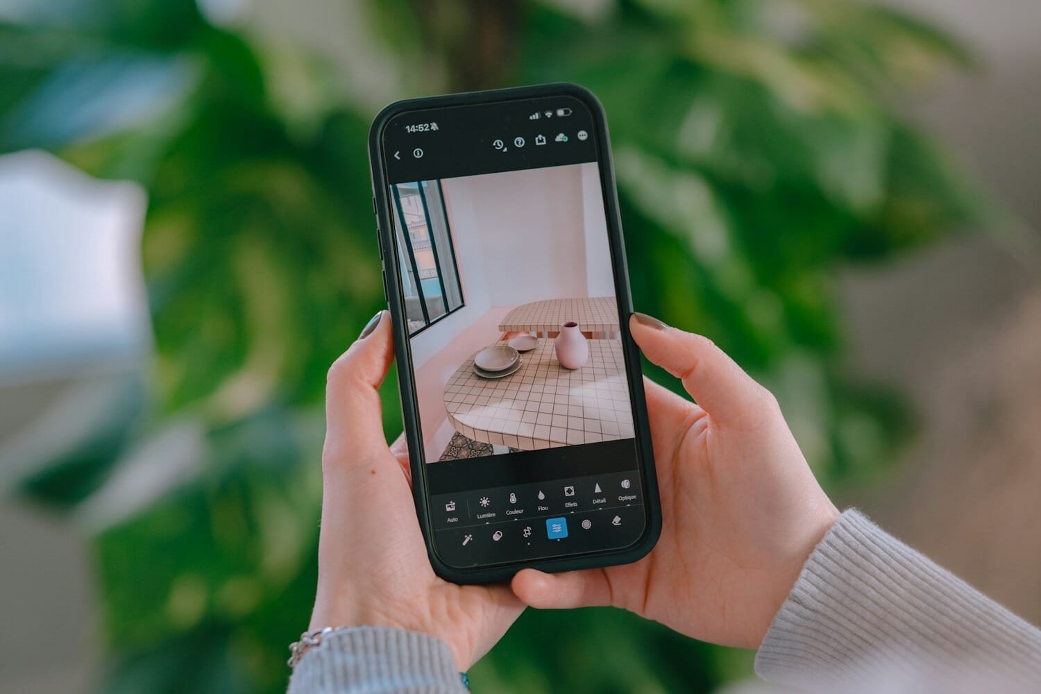 Person editing a photo on their smartphone using a mobile editing app