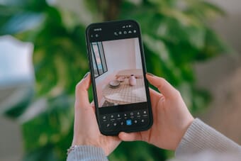 Person editing a photo on their smartphone using a mobile editing app